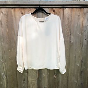 Aware by Vero Moda Cream silky top with button on the back.  Size medium.